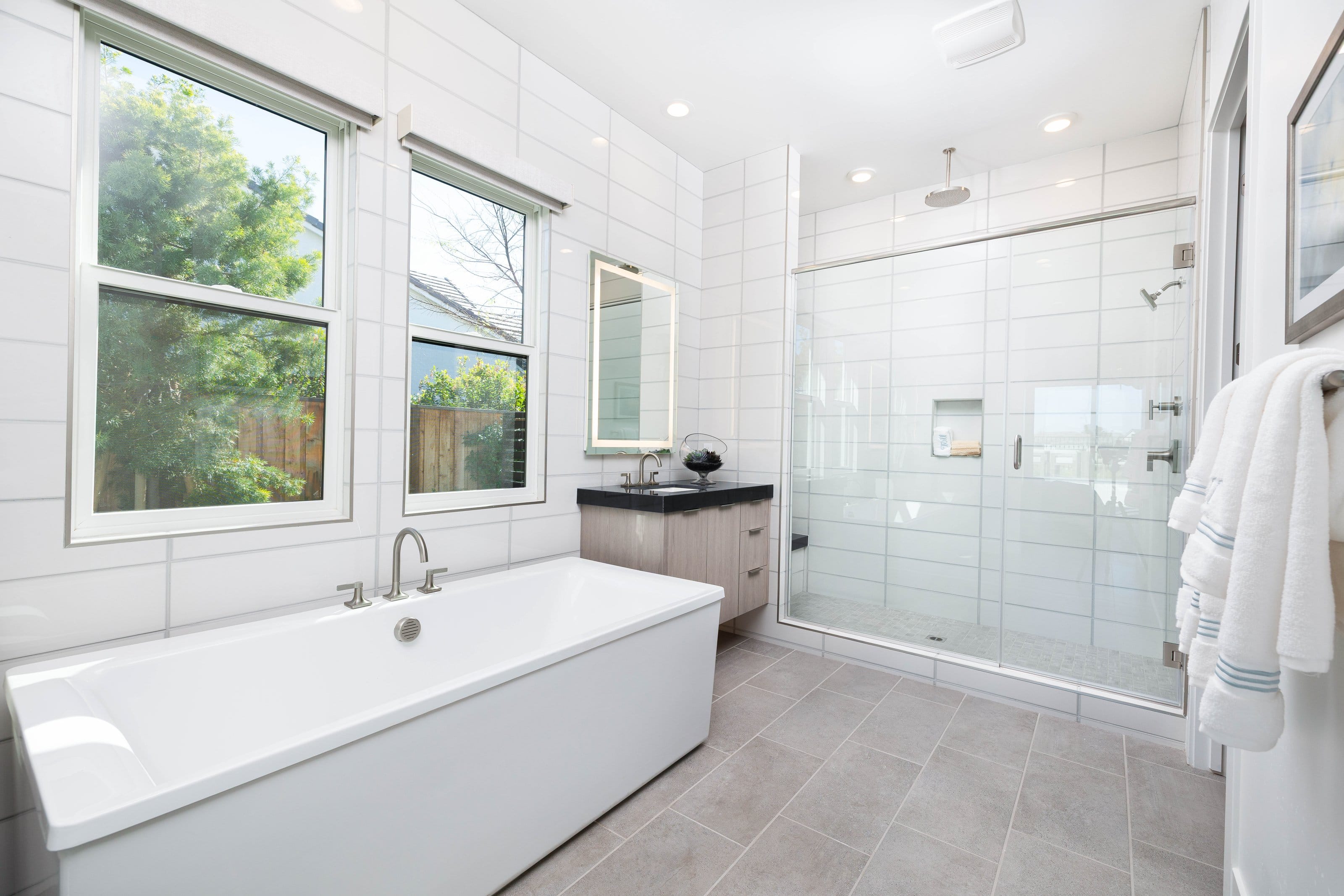 Luxury frameless shower enclosure installation in a high-end residential bathroom