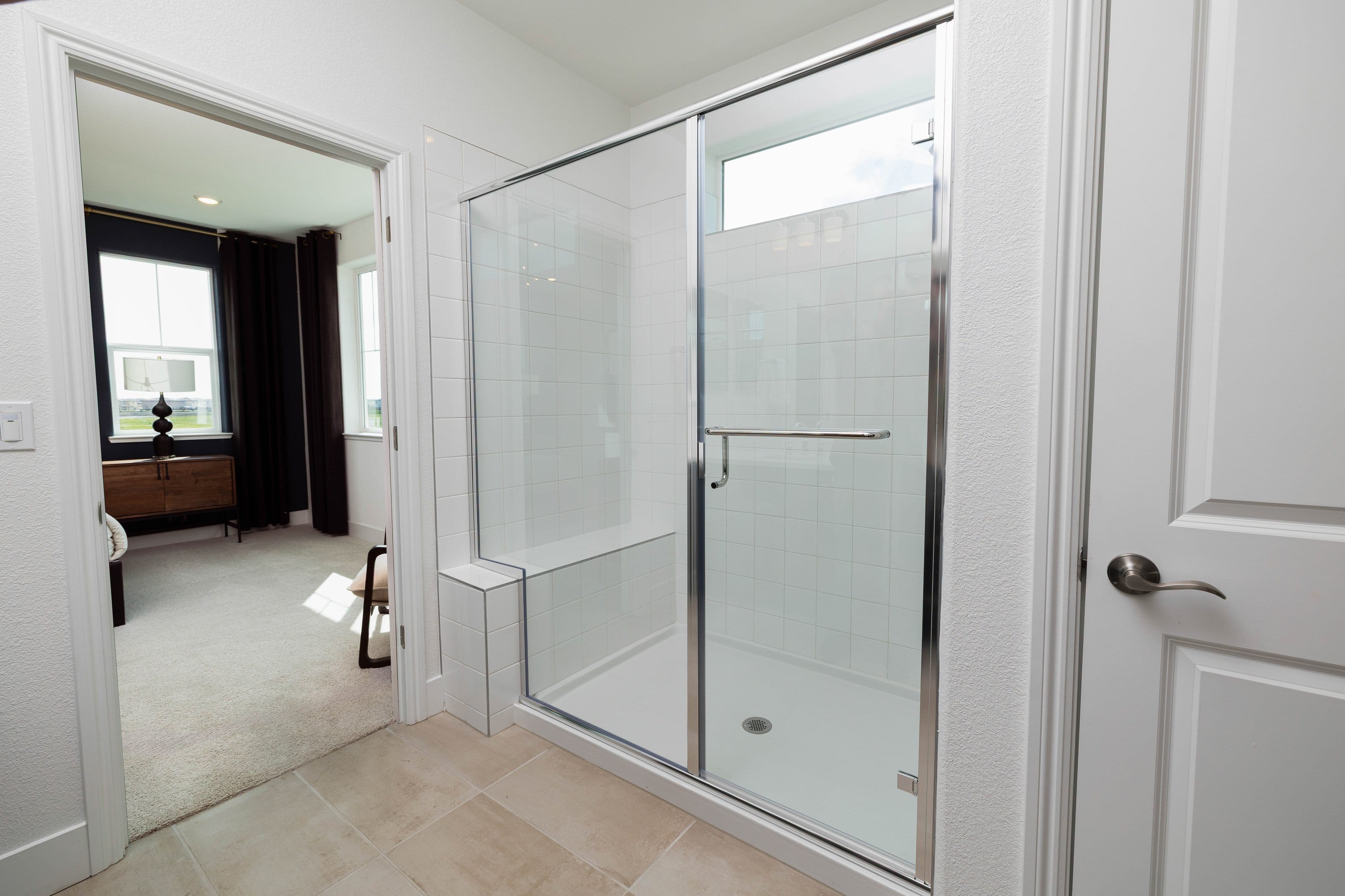 Silver-framed shower enclosure with hinged glass door