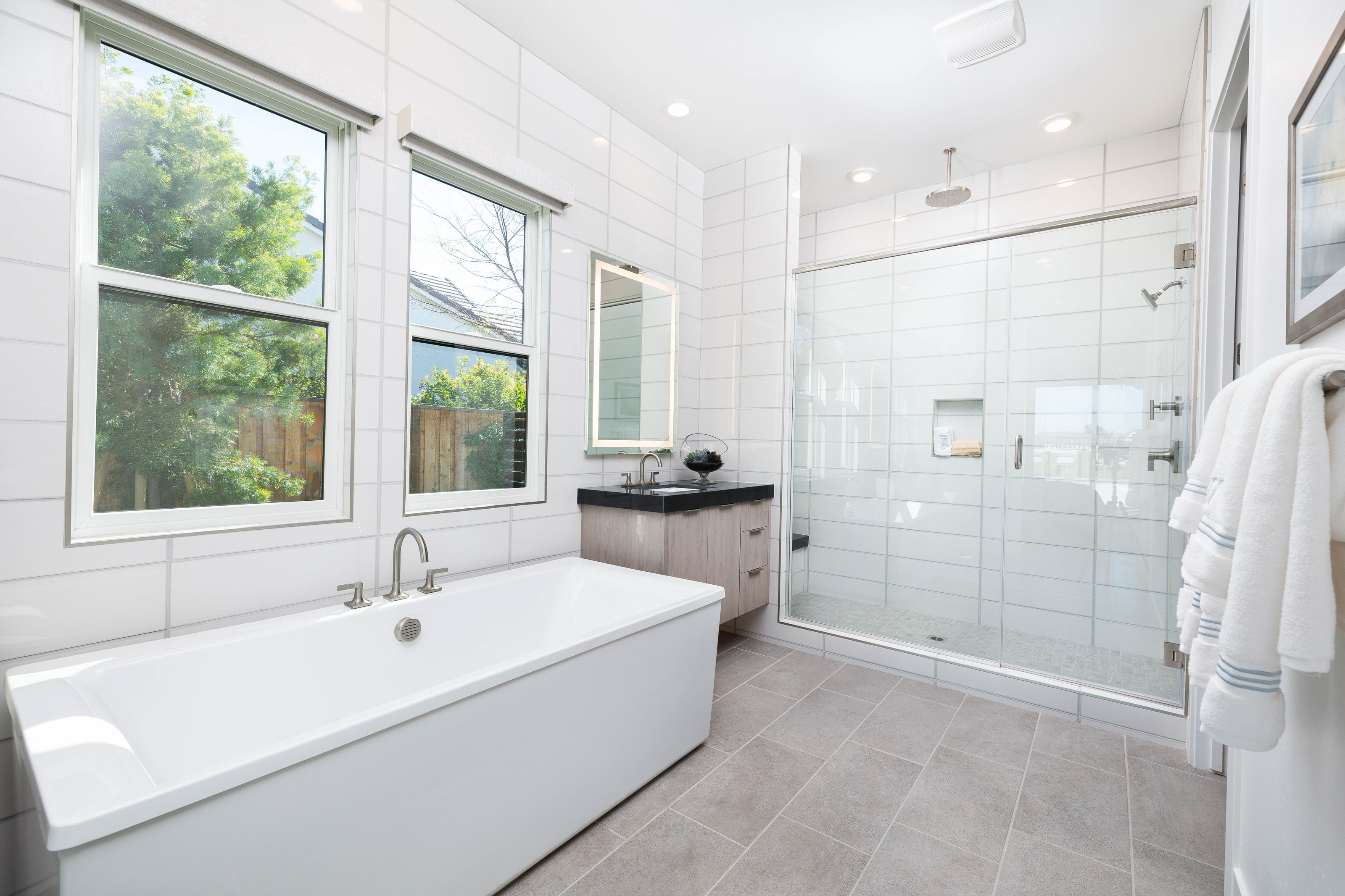 Luxury frameless shower enclosure with glass panels in a modern bathroom