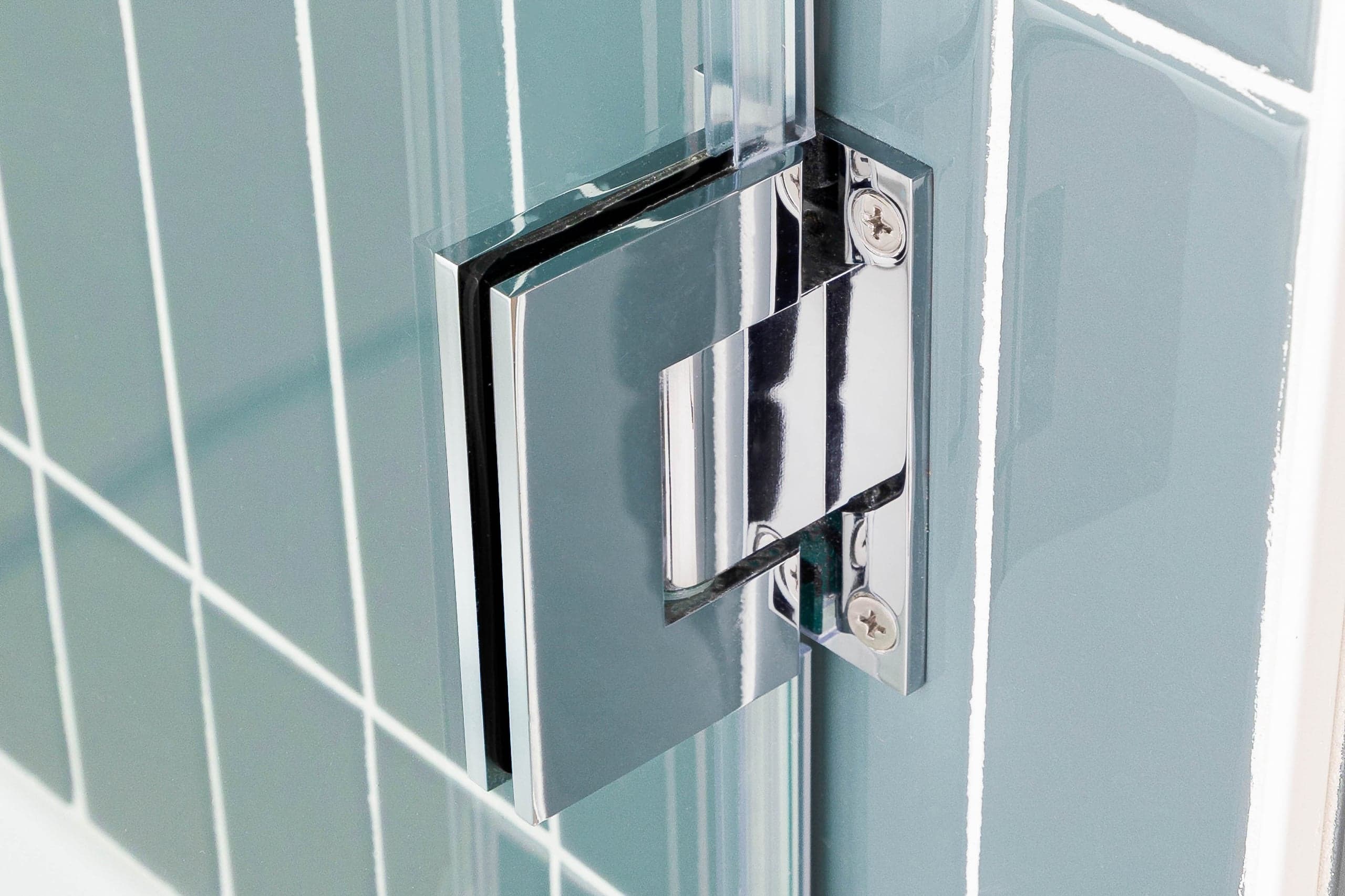 Chrome wall-mount bracket fixing a glass panel on an Infinity Glass and Glazing installation