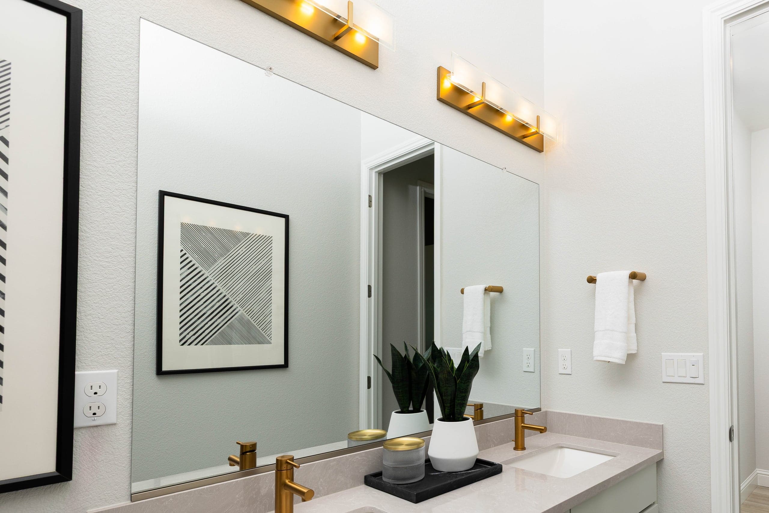 Over-vanity custom mirror installed at accessible height in a Denton Robson Ranch primary bathroom